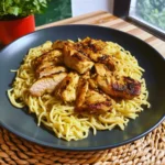 A delicious plate of Garlic Butter Chicken Pasta topped with tender chicken and herbs.