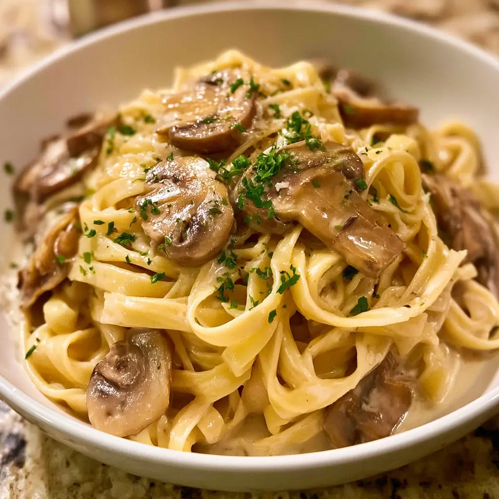 Plate of creamy mushroom pasta with garlic and parmesan sauce