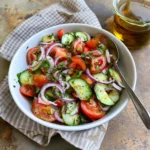 Marinated Cucumber, Tomato, and Onion Salad served in a bowl