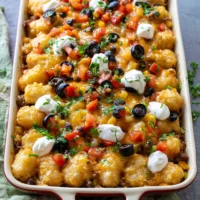 Delicious Mexican Tater Tot Casserole topped with crispy tater tots and cheese.