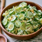 Crispy and creamy Million Dollar Cucumber Salad with bacon, cheddar, and green onion.