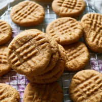 Delicious homemade peanut butter cookies stacked on a plate.