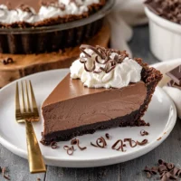 Marie Callenders Chocolate Satin Pie with creamy filling and buttery crust topped with whipped cream.