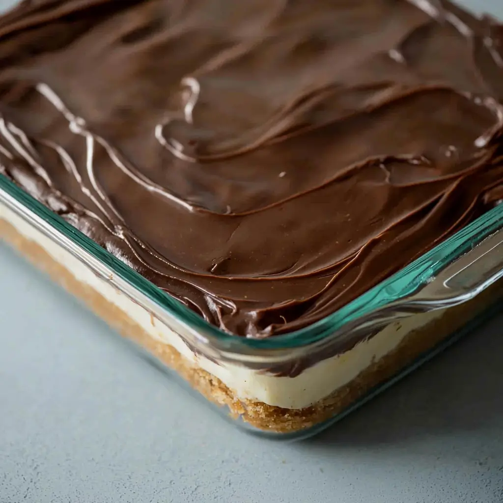 No-bake Chocolate Eclair Cake with layers of graham crackers and chocolate frosting