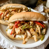 Chicken Philly Sandwich filled with peppers, onions, and melted cheese on a hoagie roll