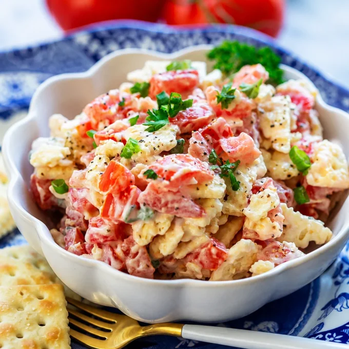 Georgia Cracker Salad featuring saltines, tomatoes, eggs, and mayonnaise in a bowl.